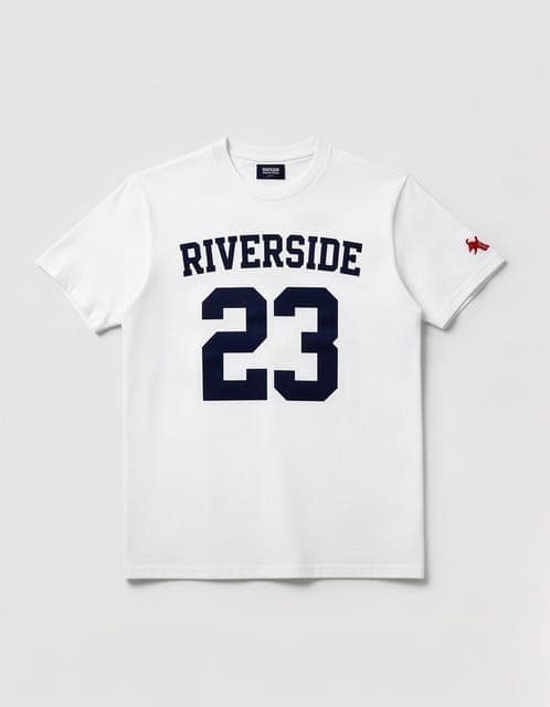 Garment photo: a white t-shirt laid flat with RIVERSIDE 23 printed in navy and a small red sleeve logo